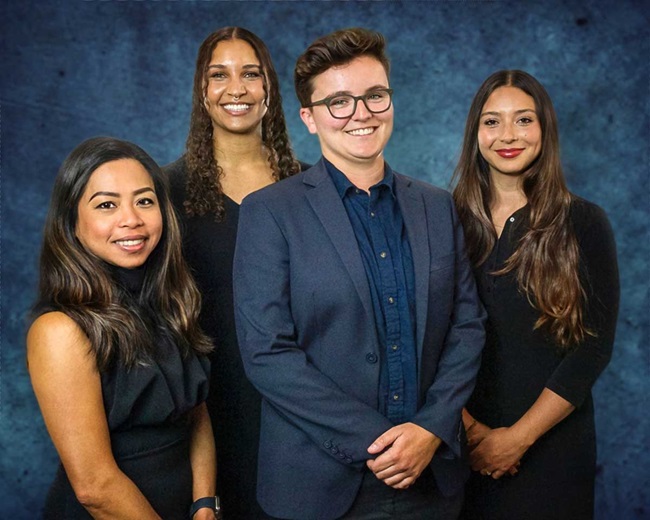 Four people on blue background. 