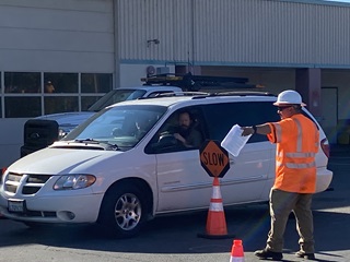 Image of Caltrans employee directing local community member during local Caltrans Dump Day.