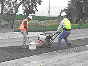 Workers laying stamped concrete