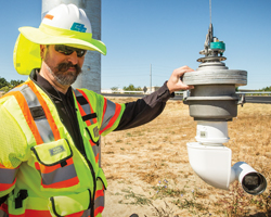 Photo of Caltrans engineer David Butler poses with a closed-circuit television camera