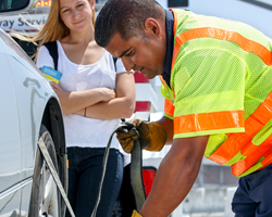 Photo thumbnail of a Freeway Service Patrol driver assisting a woman on a freeway.