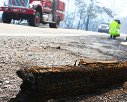 Photo of a highway, fallen sign and fire truck along highway 128 during the Napa fire in August 2020.