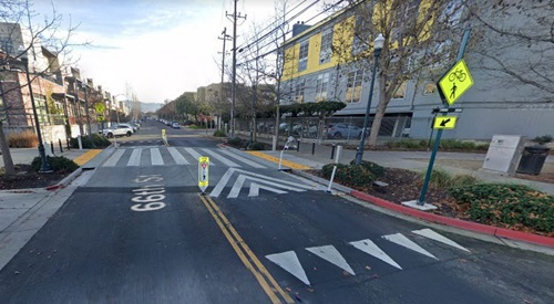 Image of a speed table that runs transverse to the direction of traffic with a ramp up followed by a flat section and ramp down