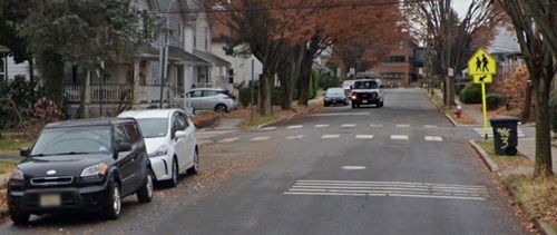 Image of transverse rumble strips that have raised or grooved patterns perpendicular to the direction of travel in the roadway travel lane providing an audible and tactile warning of a downstream decision point