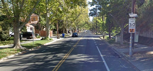 Image of a traveled roadway with a speed feedback sign showing posted speed limit and digital feedback about drivers speed